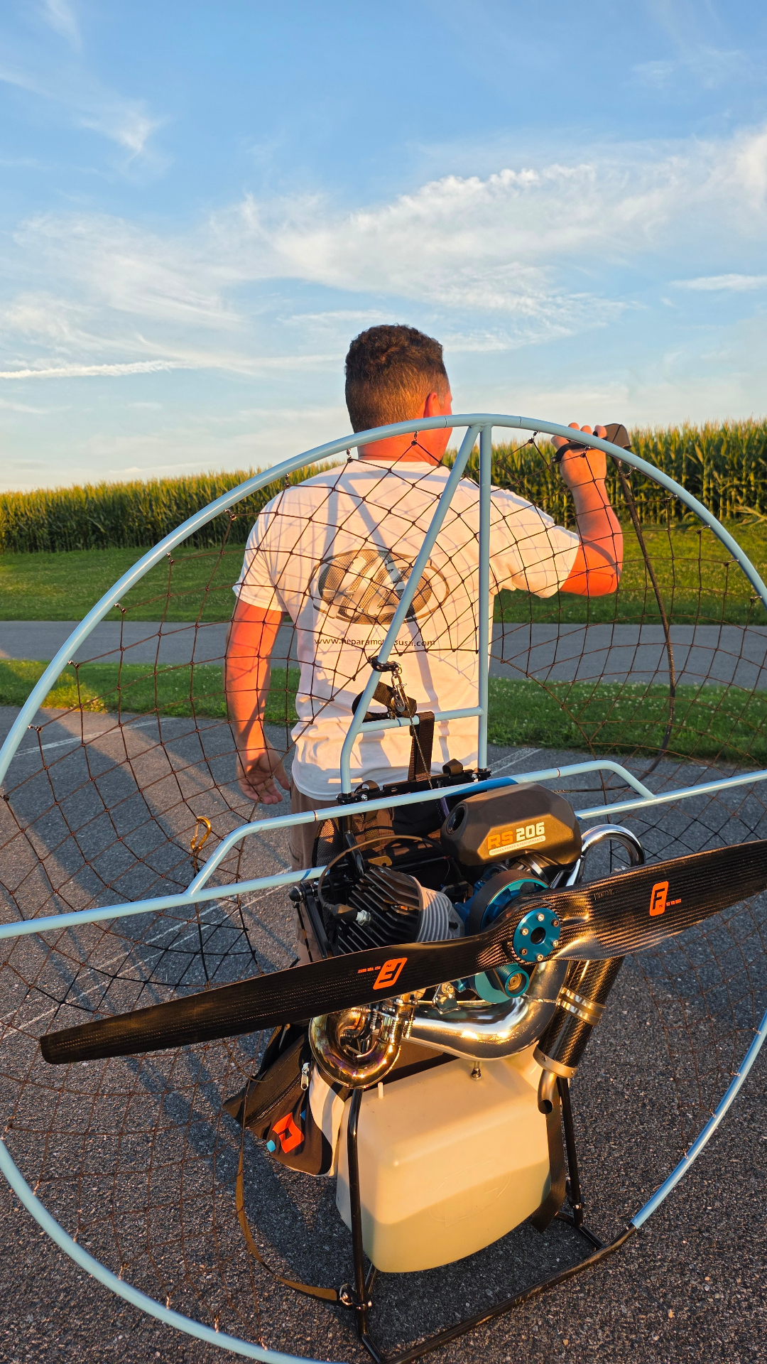 Pilot with an HE RS 206 paramotor and carbon propeller at sunset